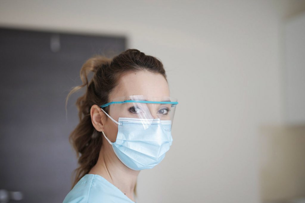healthcare worker in face mask and shield